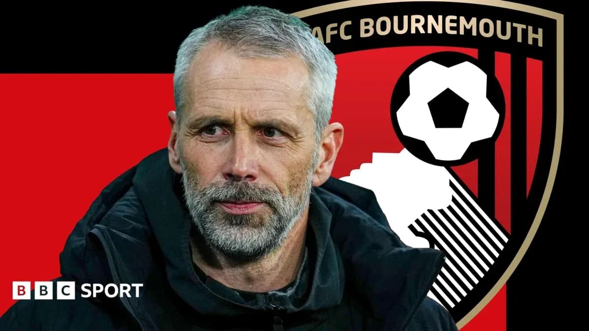 AFC Bournemouth manager in front of club logo AFC Bournemouth manager in front of club logo