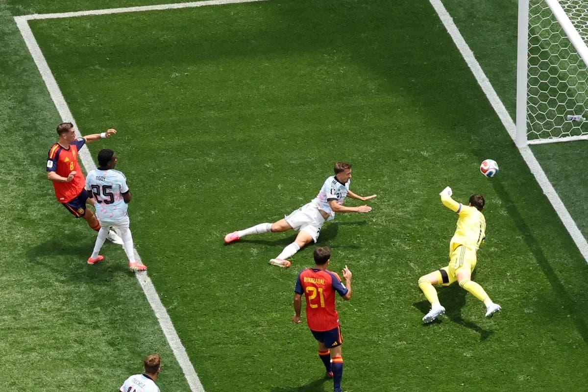 Player attempting to score while goalkeeper makes save Player attempting to score while goalkeeper makes save