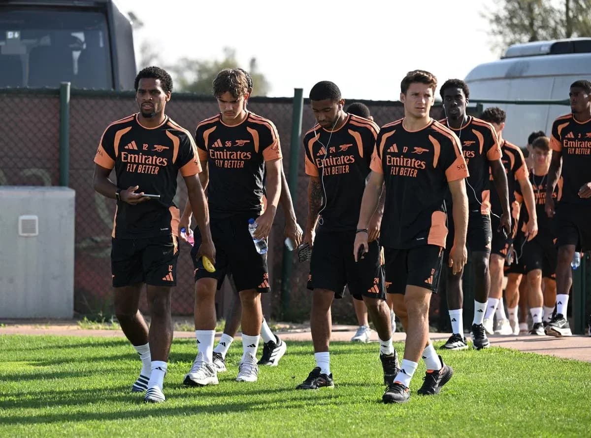 Arsenal players walking on training ground in uniforms Arsenal players walking on training ground in uniforms
