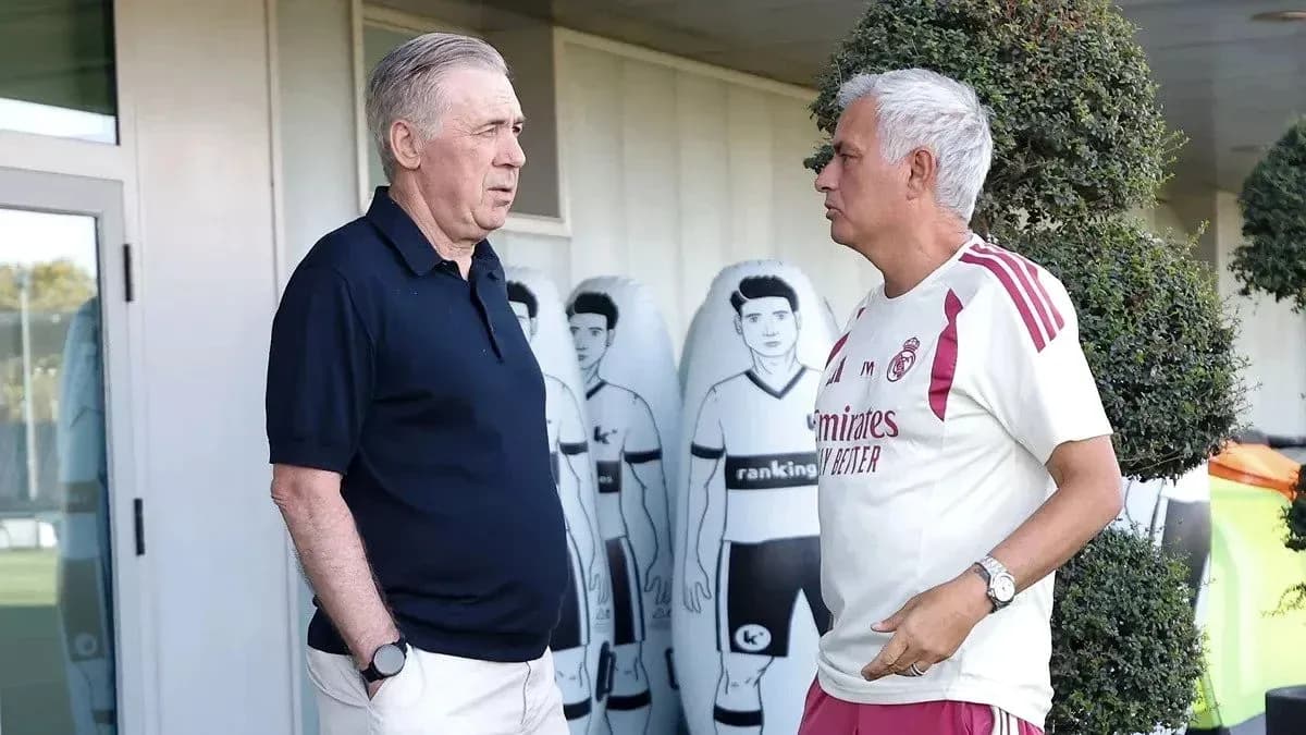 Two coaches conversing outside training facility Two coaches conversing outside training facility