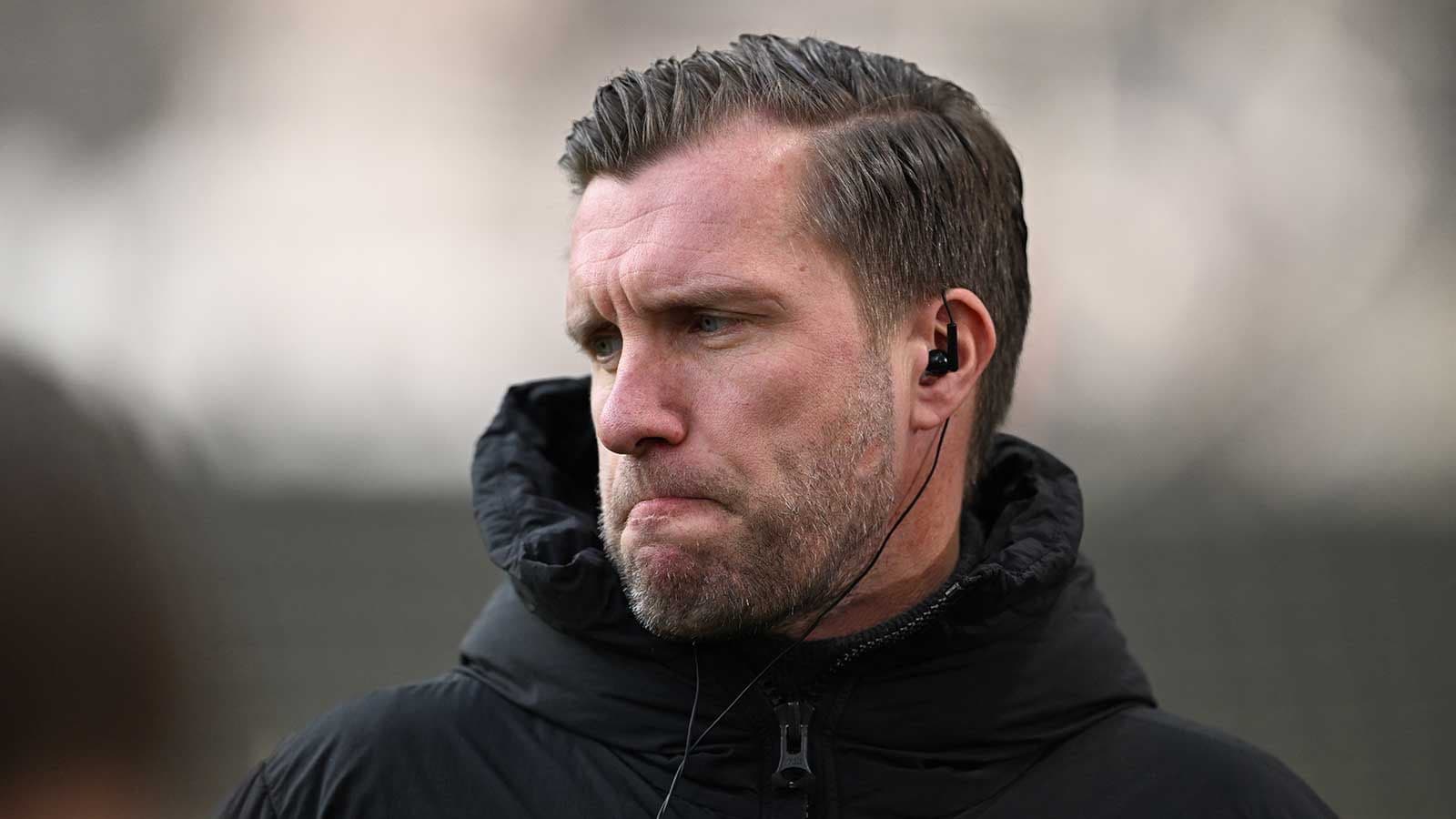 Coach with earpiece during training session Coach with earpiece during training session