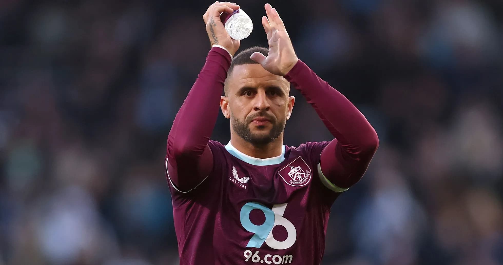 Player applauding fans while holding a water bottle Player applauding fans while holding a water bottle