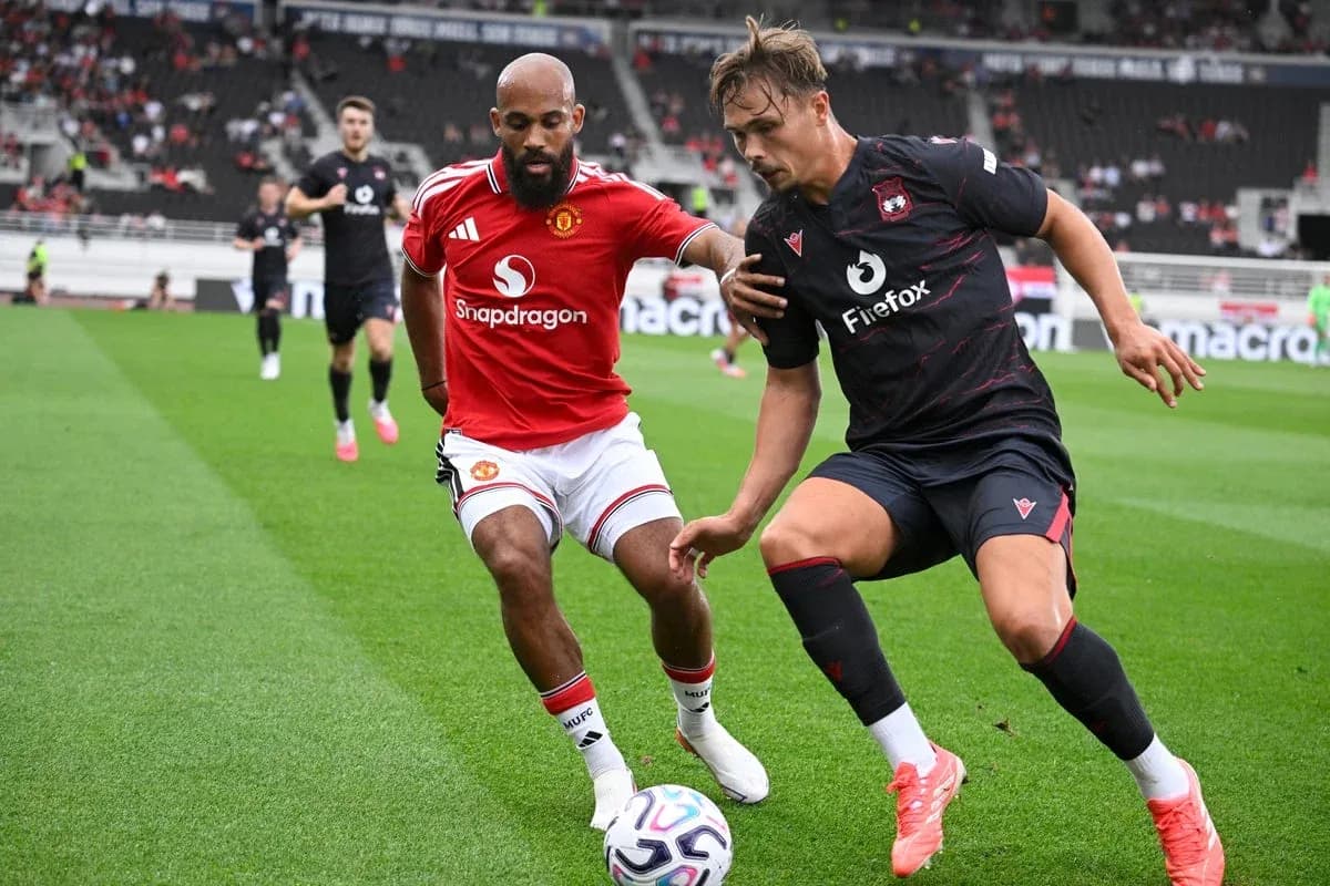 Two players competing for the ball on field Two players competing for the ball on field