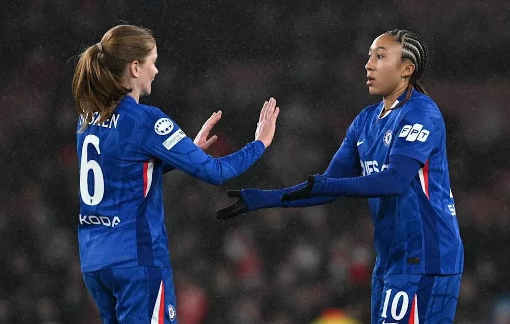 Two Chelsea players exchanging a high five during match Two Chelsea players exchanging a high five during match