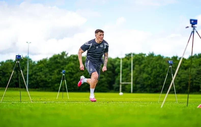 Player sprinting during training session on pitch Player sprinting during training session on pitch