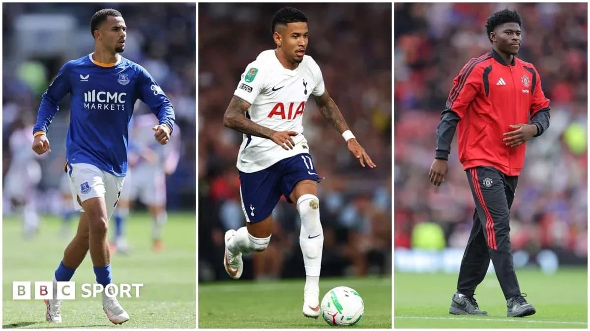 Three football players in team kits on field Three football players in team kits on field