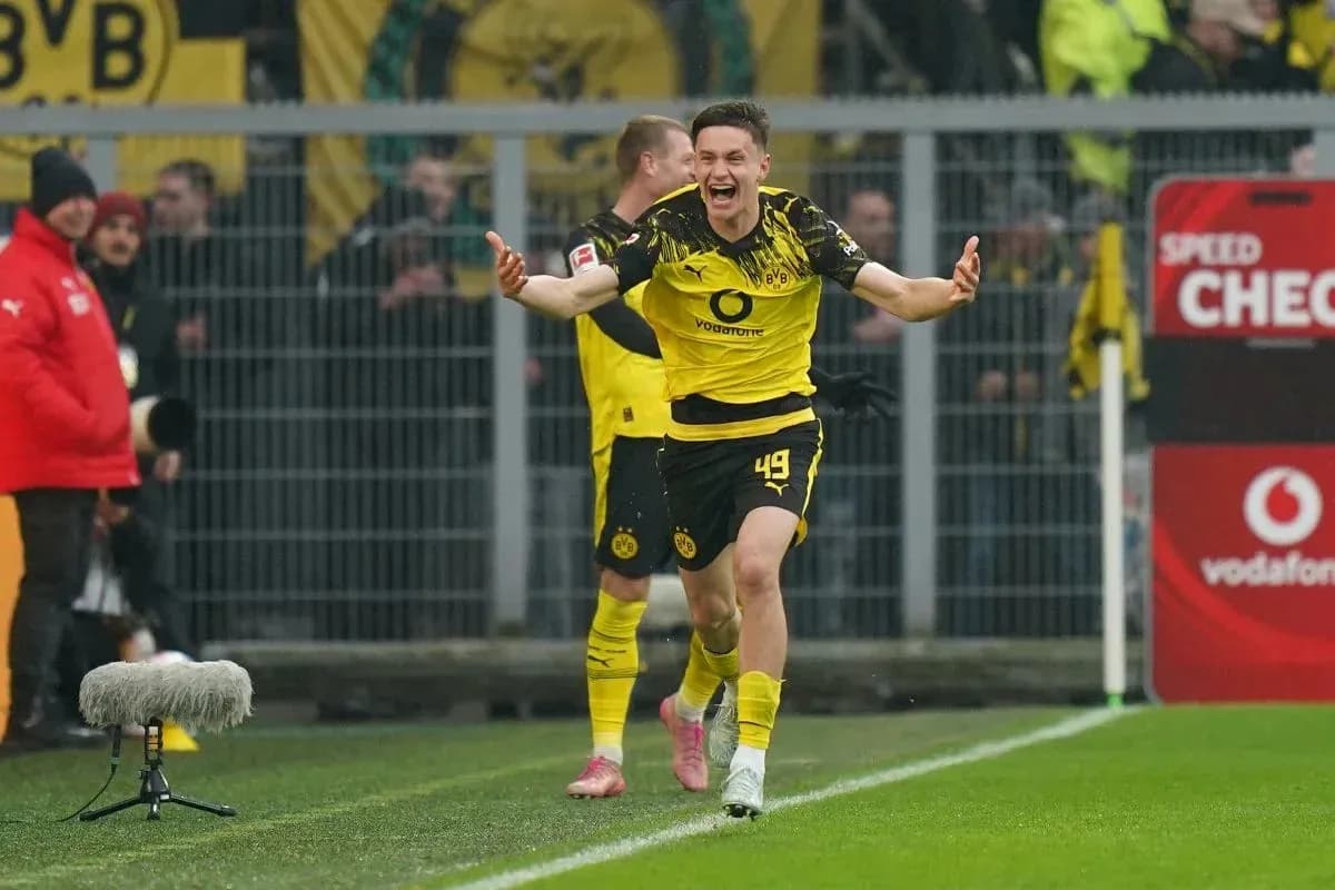 Player celebrating goal on the field for Borussia Dortmund Player celebrating goal on the field for Borussia Dortmund