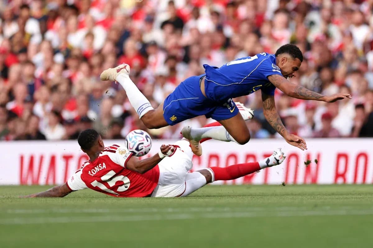 Player falling over opponent during football match Player falling over opponent during football match