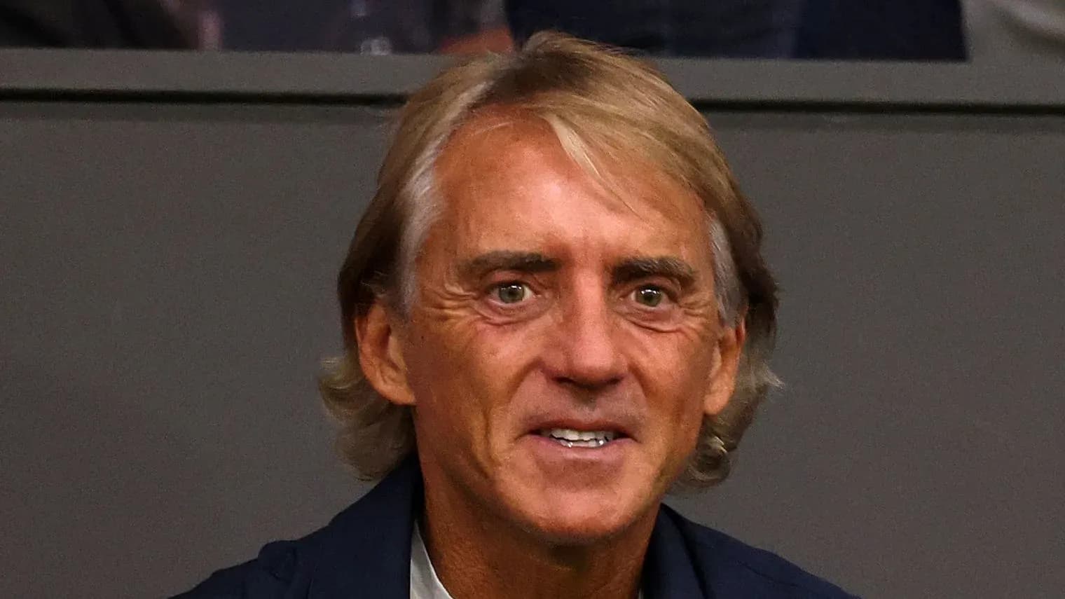 Coach sitting in stands during a match Coach sitting in stands during a match