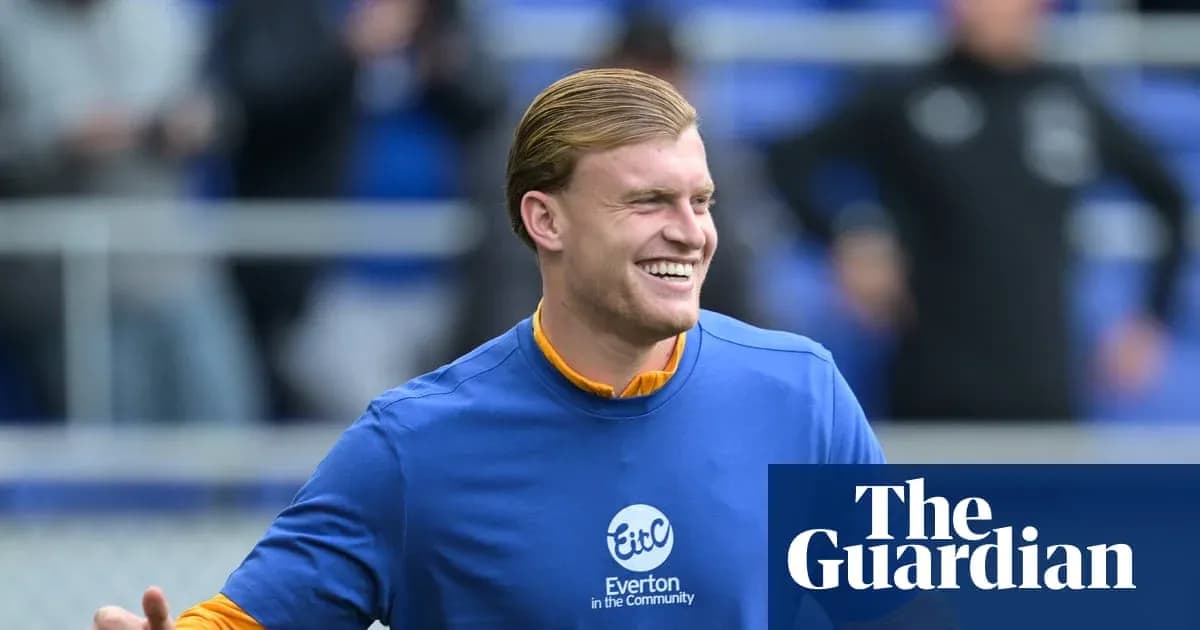 Player smiling during warm-up at Everton training session Player smiling during warm-up at Everton training session