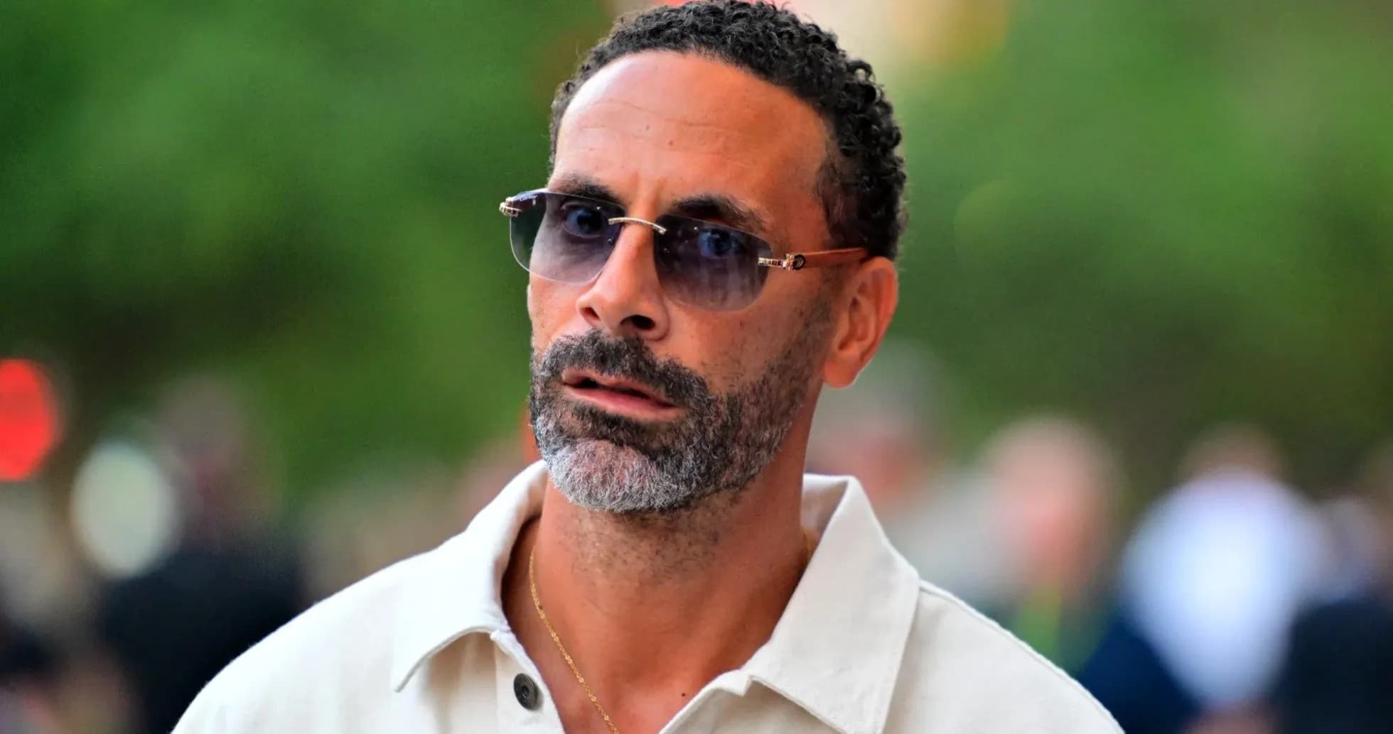 Man wearing sunglasses walking outdoors Man wearing sunglasses walking outdoors
