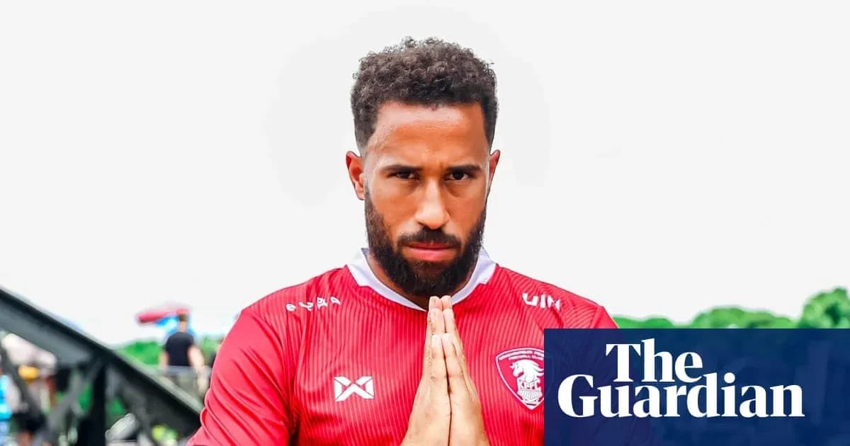 Player posing in red jersey with hands together Player posing in red jersey with hands together