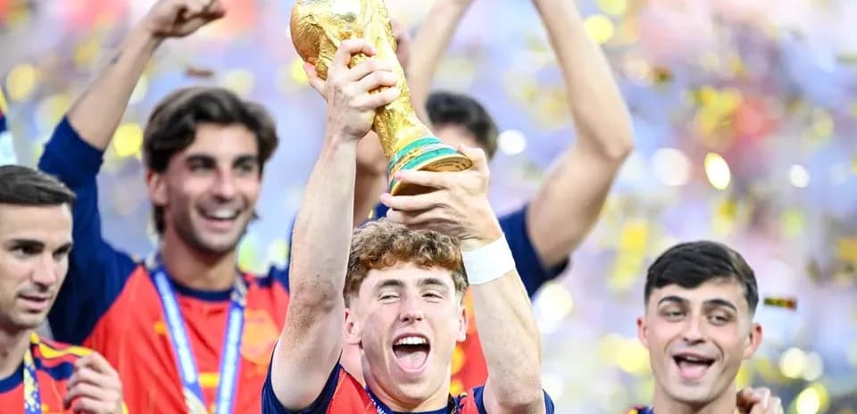 Player celebrating with FIFA World Cup trophy and teammates Player celebrating with FIFA World Cup trophy and teammates