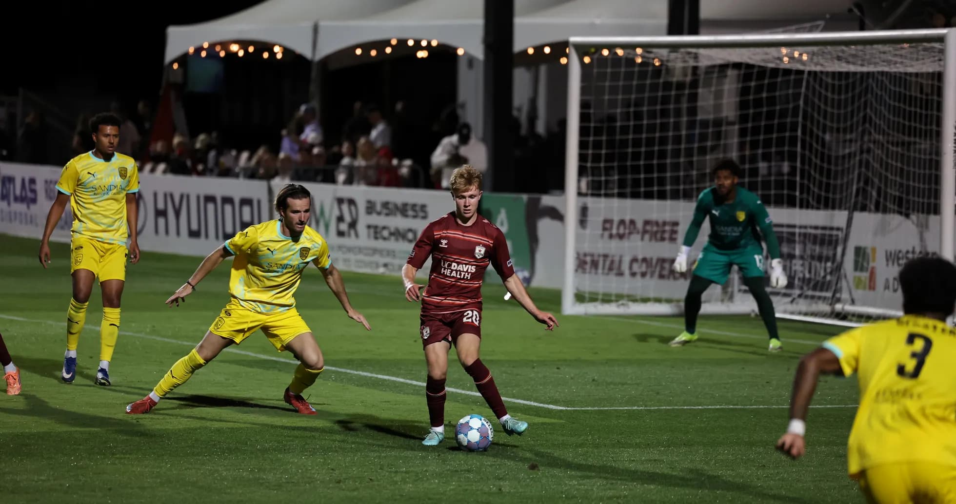 Players competing for the ball in USL Championship match Players competing for the ball in USL Championship match