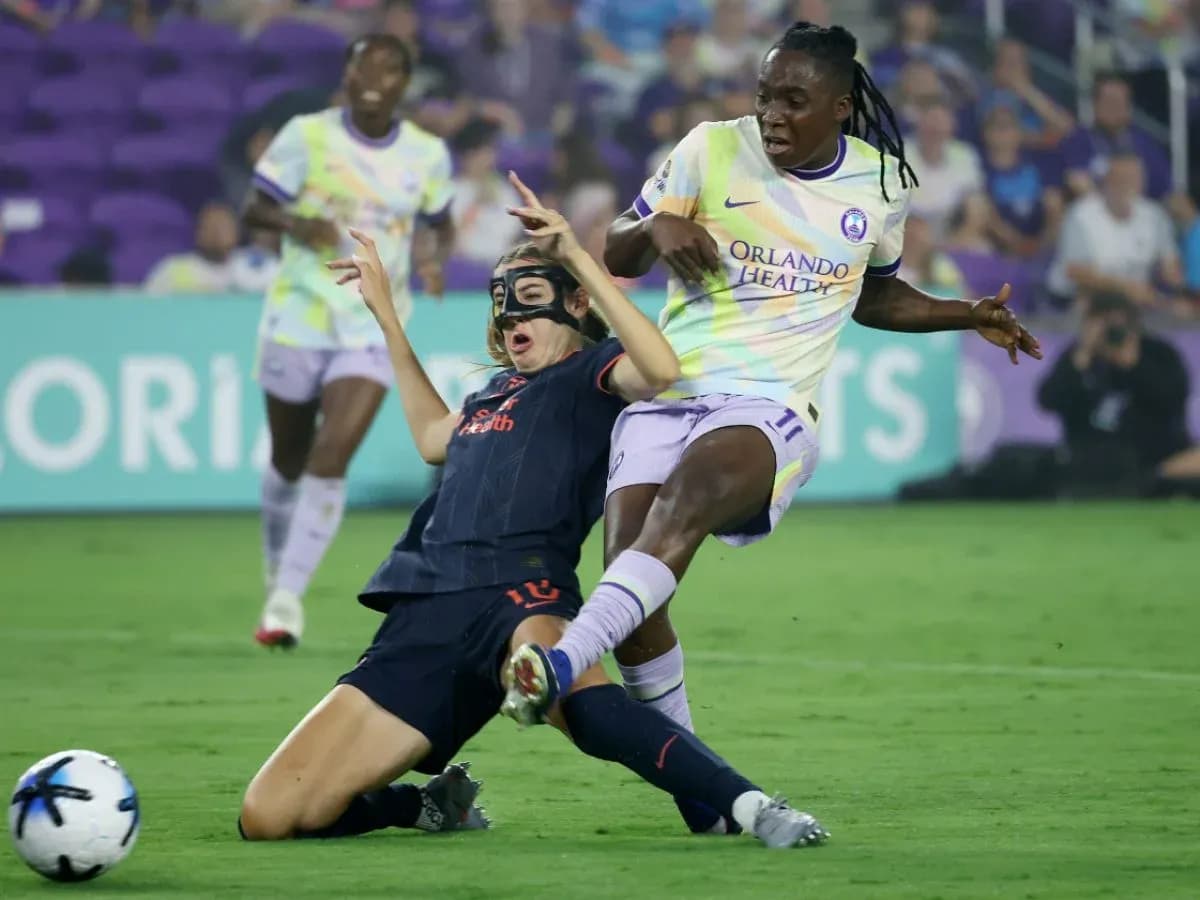Player tackles opponent during NWSL match Player tackles opponent during NWSL match