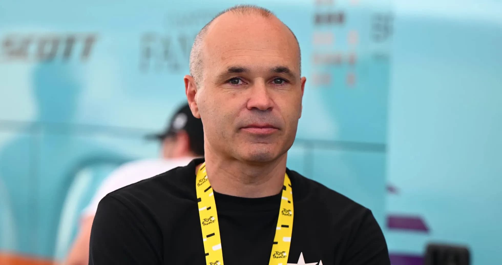 Person with a lanyard at cycling event backdrop Person with a lanyard at cycling event backdrop