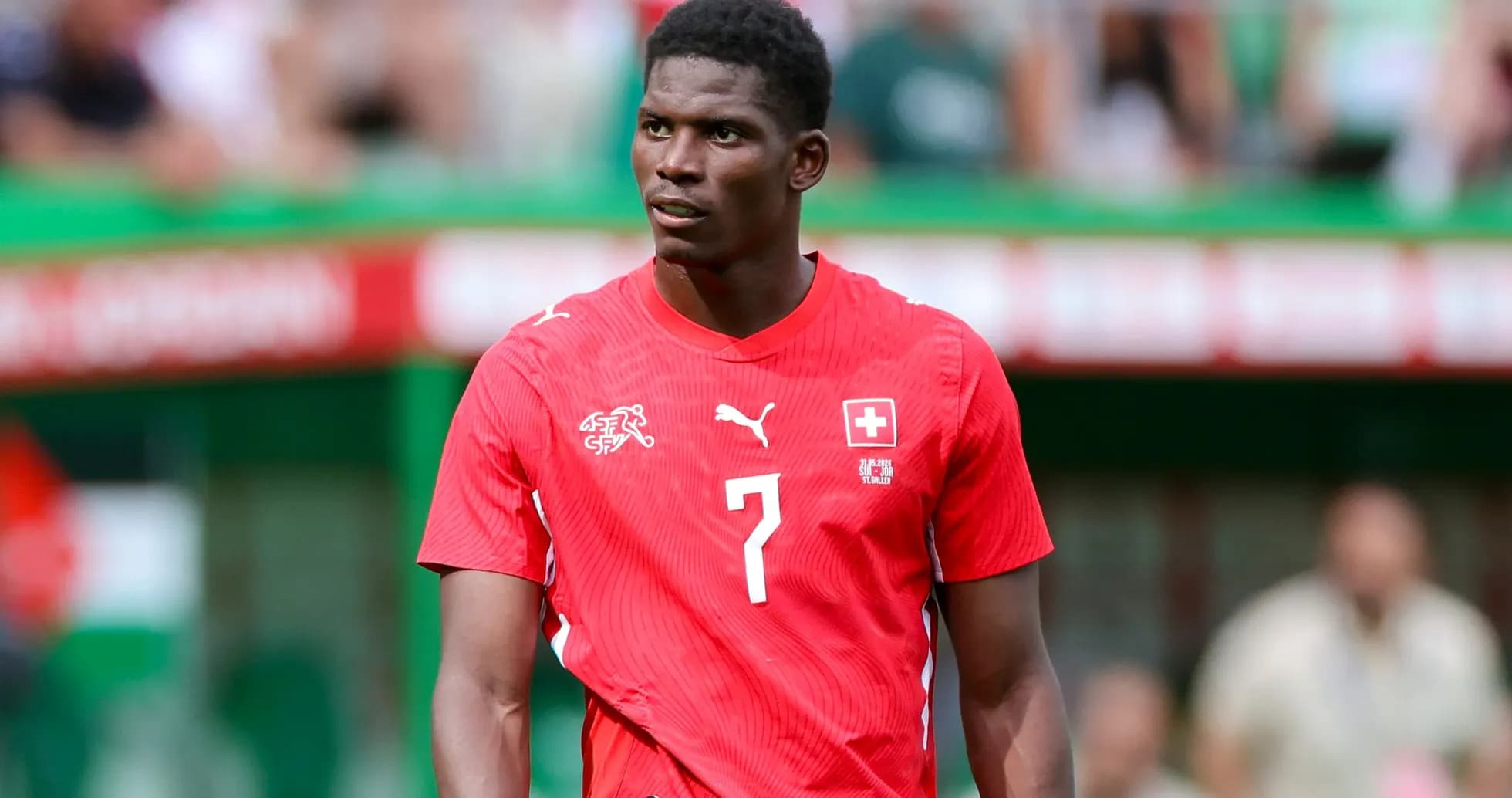 Player in red jersey during a football match Player in red jersey during a football match
