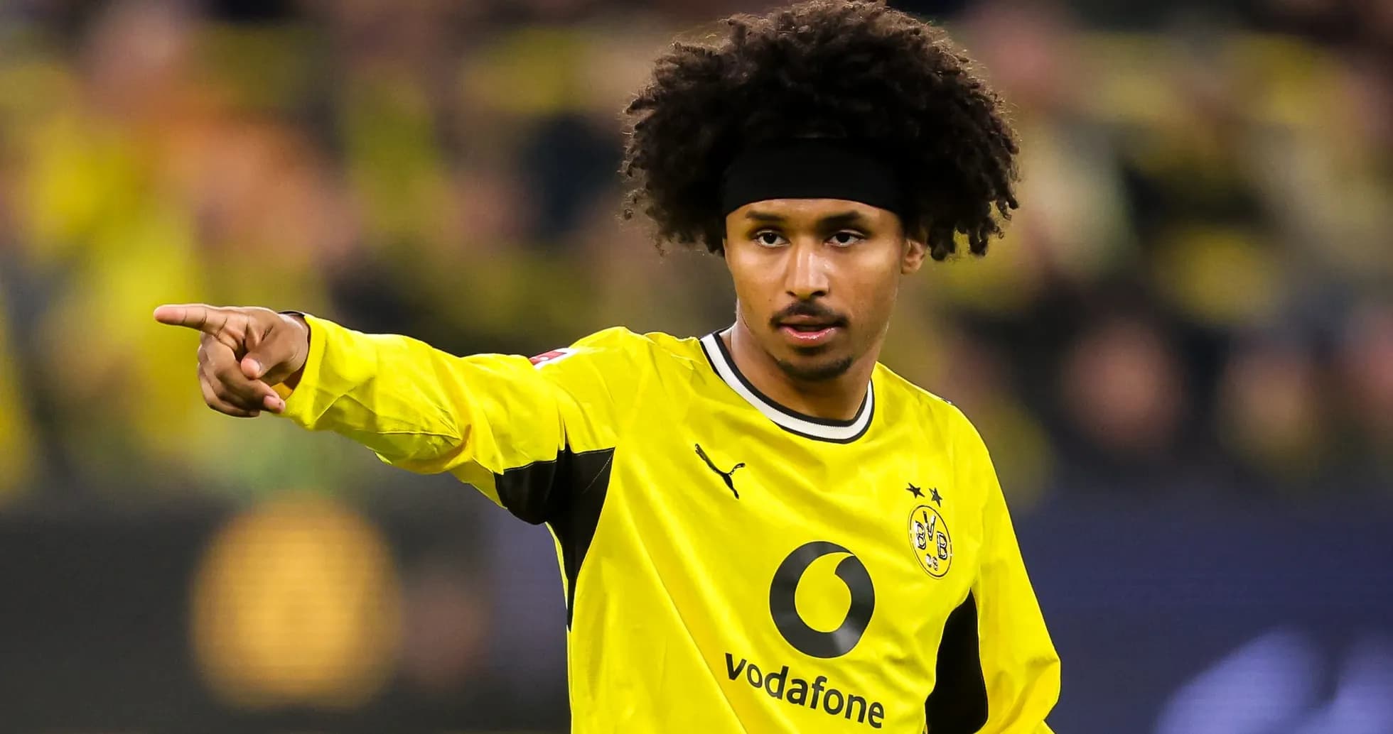 Player pointing during a match in yellow jersey Player pointing during a match in yellow jersey