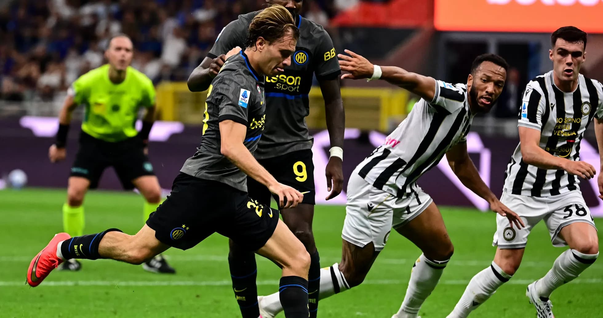 Inter player sprinting past Udinese defenders during match Inter player sprinting past Udinese defenders during match