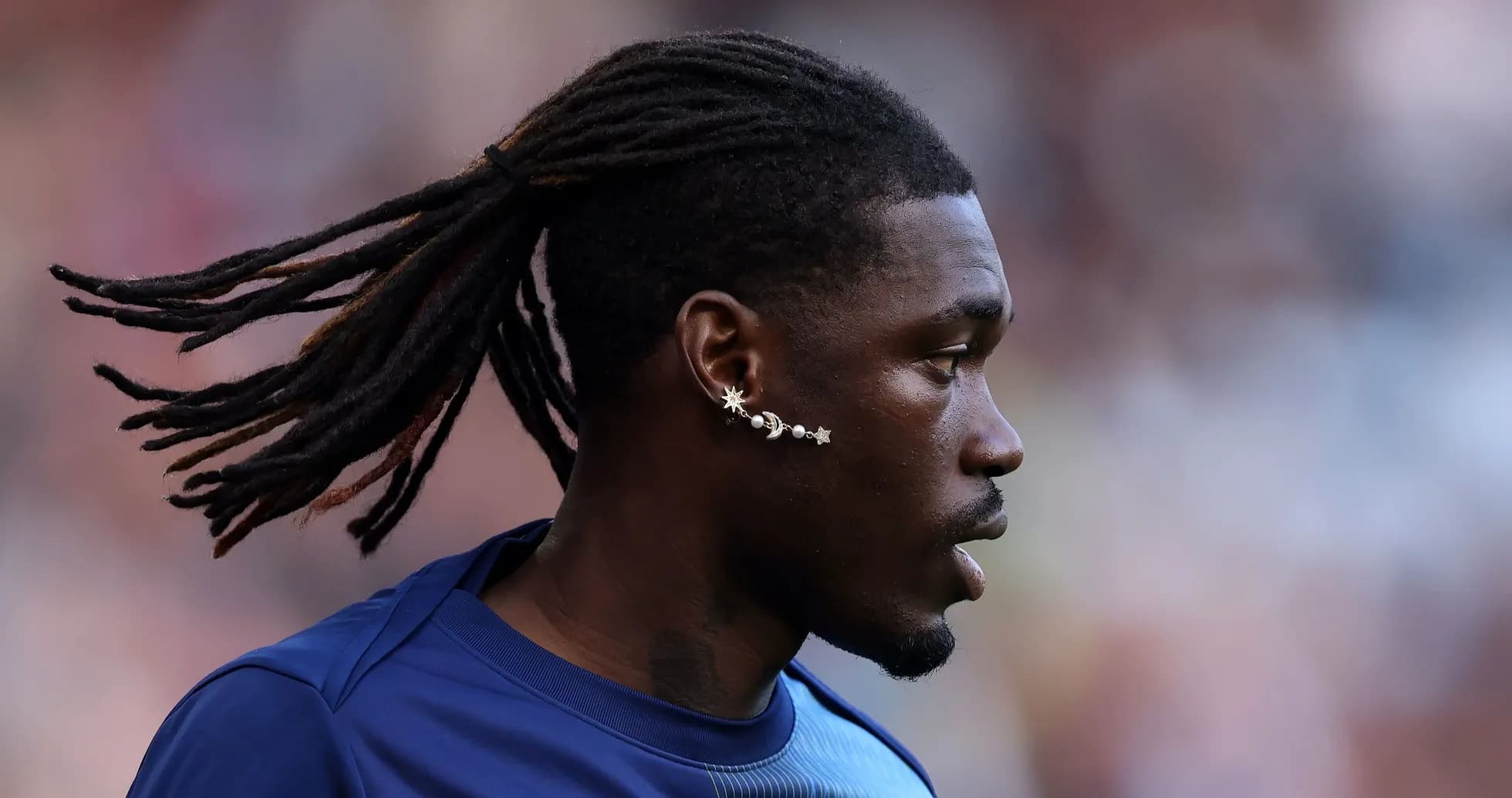 Player with long hair and unique ear jewelry Player with long hair and unique ear jewelry
