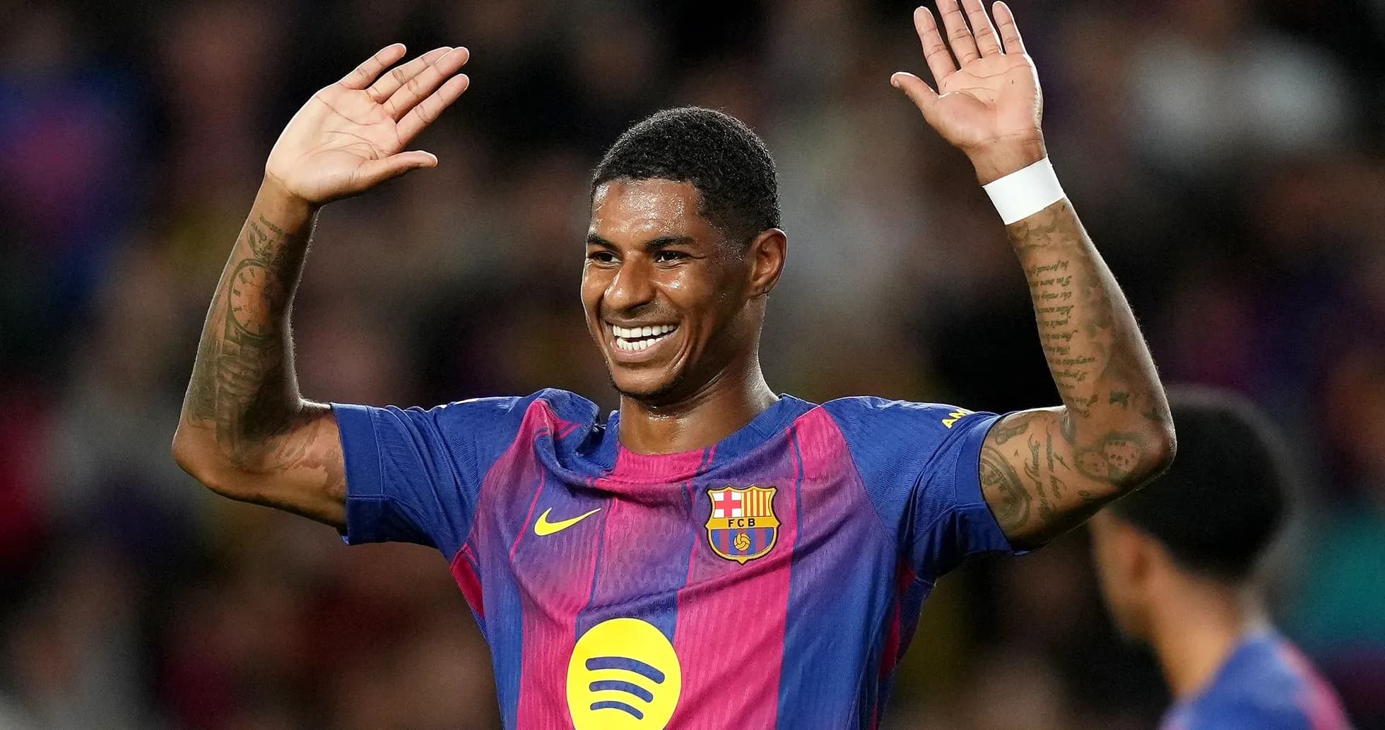 Player celebrating with hands raised on field Player celebrating with hands raised on field