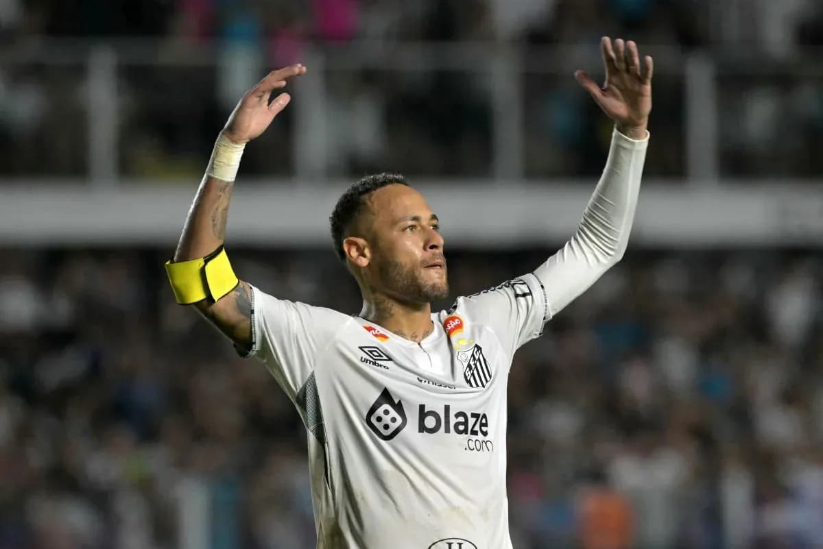 Player celebrating in Santos FC jersey with arms raised Player celebrating in Santos FC jersey with arms raised