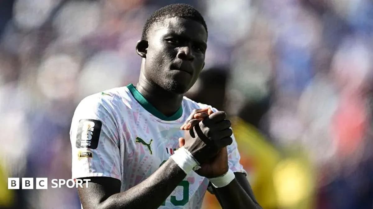 Player in national team jersey with clasped hands Player in national team jersey with clasped hands