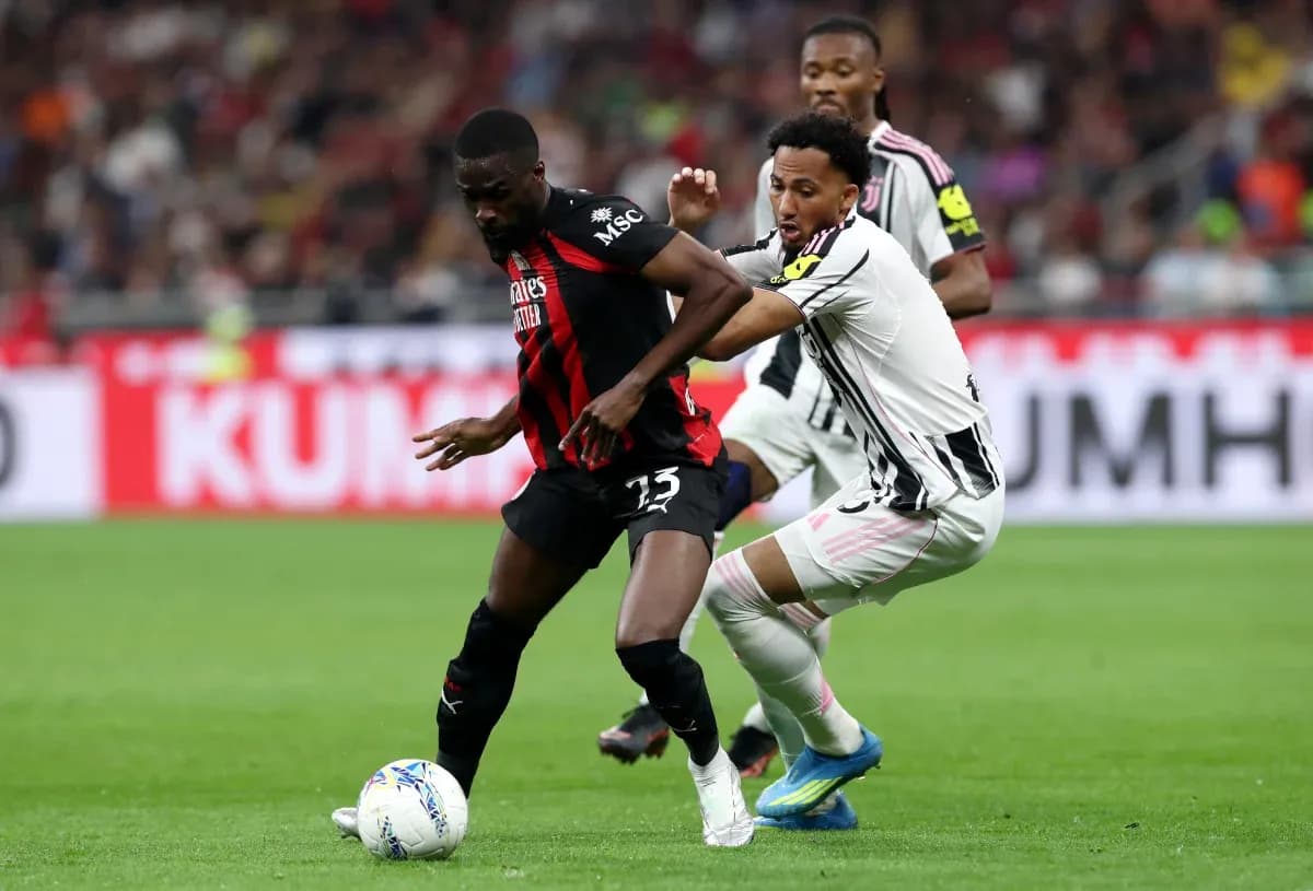 Juventus player tackling AC Milan opponent Juventus player tackling AC Milan opponent