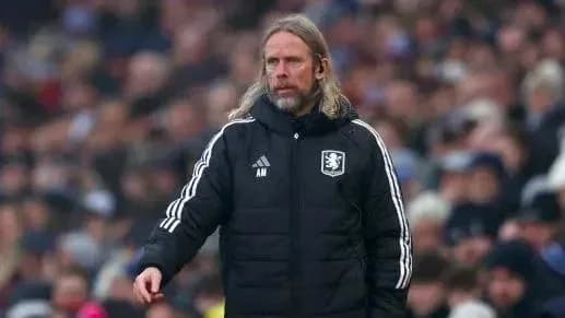 Manager in black coat on the sidelines during match Manager in black coat on the sidelines during match