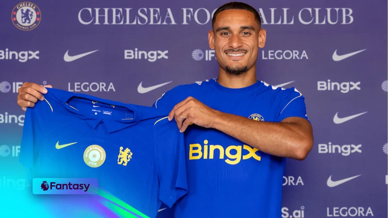 Player holding Chelsea jersey during signing event Player holding Chelsea jersey during signing event