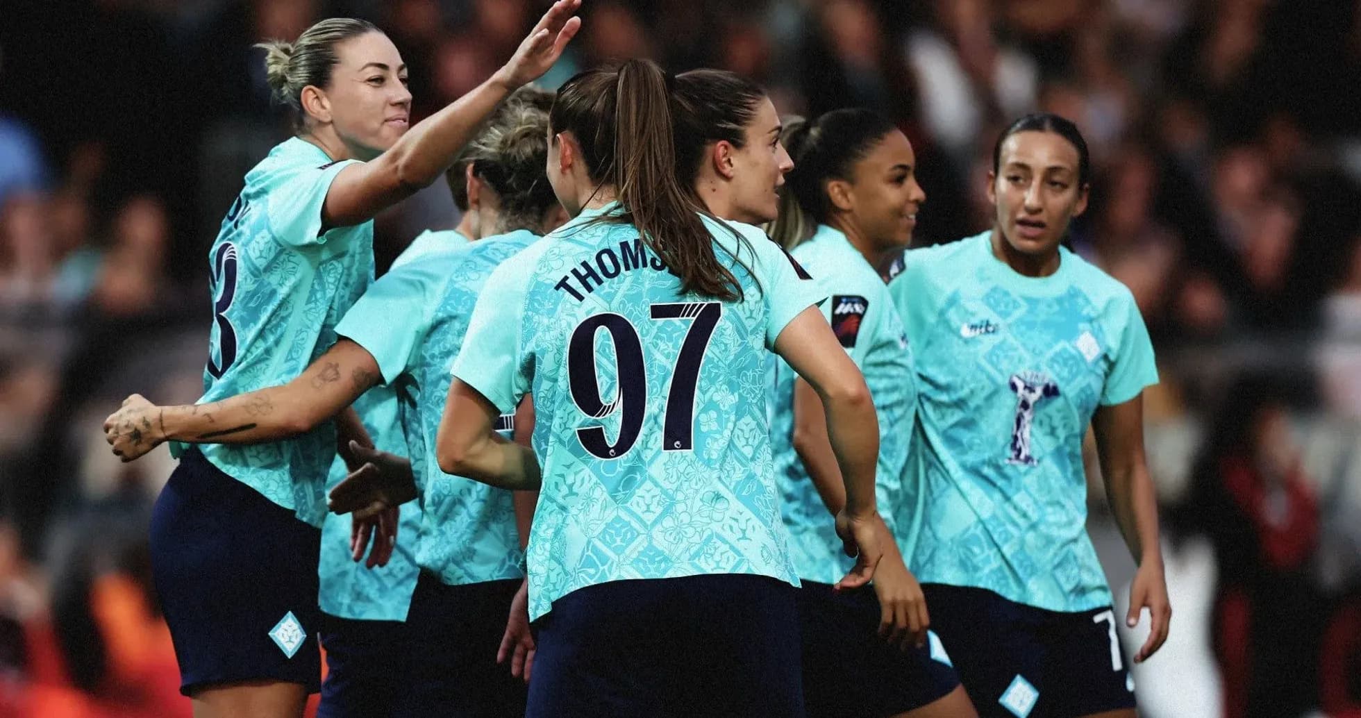 Women's football team celebrating together on the field Women's football team celebrating together on the field