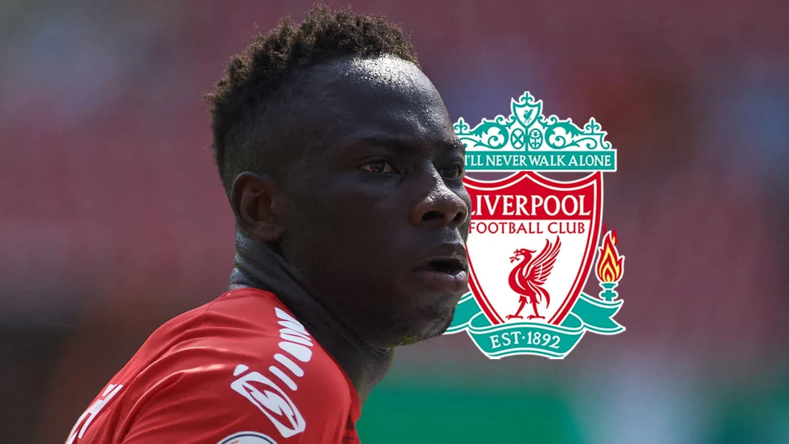 Player in red jersey with Liverpool logo background Player in red jersey with Liverpool logo background