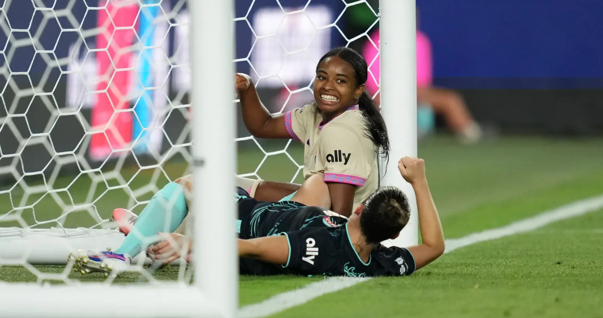 Players celebrating a goal in NWSL match Players celebrating a goal in NWSL match