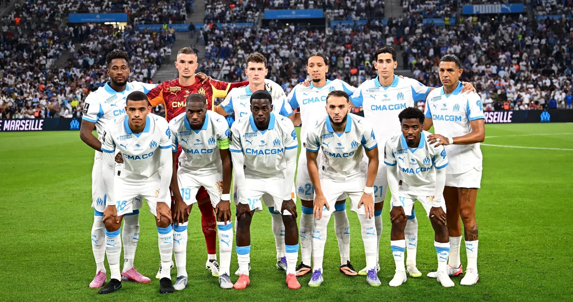 Olympique de Marseille team posing on the pitch Olympique de Marseille team posing on the pitch