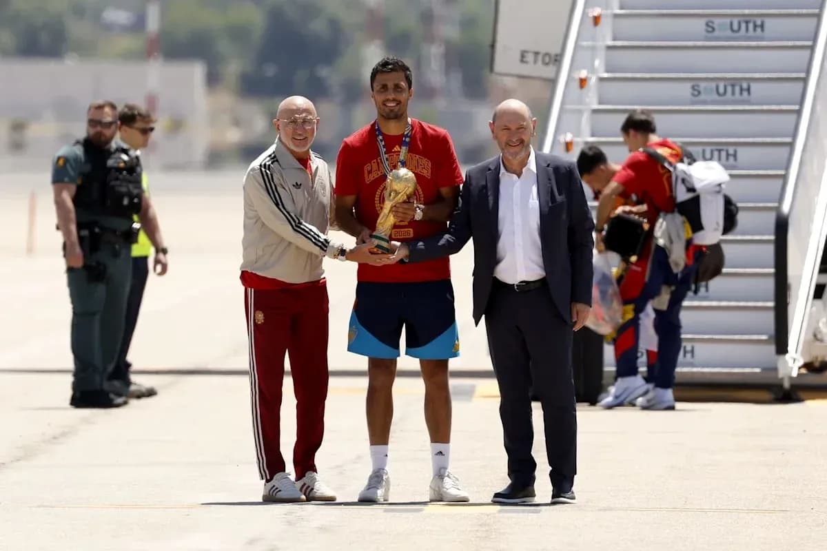 Player receiving trophy upon arrival at airport Player receiving trophy upon arrival at airport