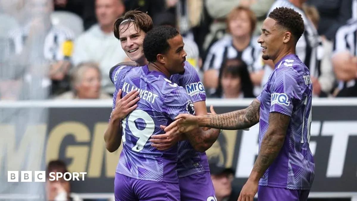 Players celebrating a goal on the pitch Players celebrating a goal on the pitch